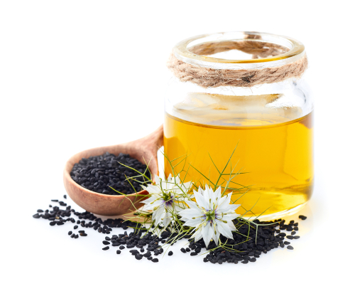 Jar of black seed oil with spoon of black seeds and black seed (nigella sativa) flowers